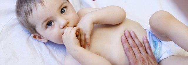 A baby id being examined for Brachial Plexus on a bed