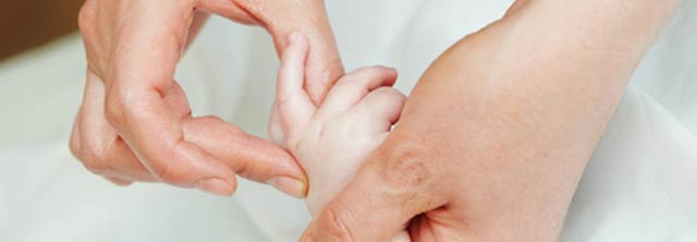 Pediatric Orthopedic Andrew E. Price MD holding a child's finger